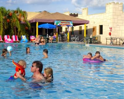 many people happily enjoying outdoor swimming pool