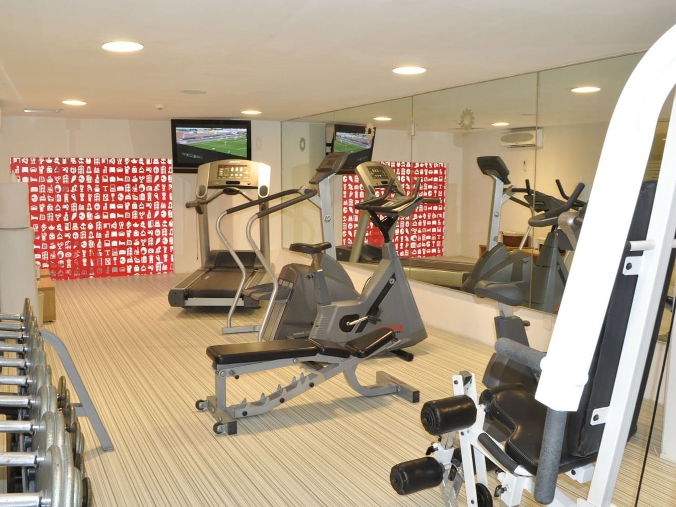 Exercise machines & Tv in a Gym Wellness Center at Fiesta Inn