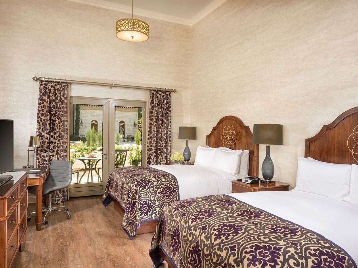 Hotel room with 2 queen beds, tv, and door to terrace
