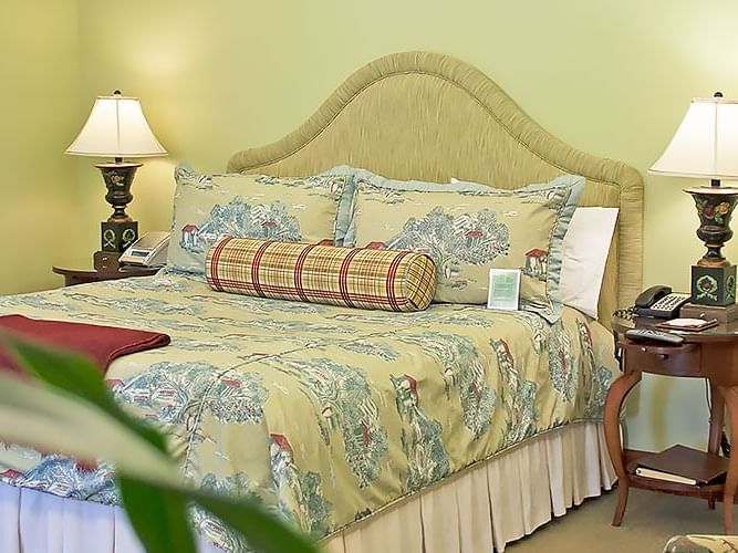 Accessible Deluxe King featuring a large bed with decorative pillows and two bedside lamps at The Rose Hotel