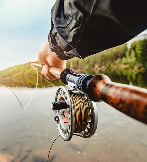 A fisherman holding a fishing rod at Coast Fort St. John Hotel