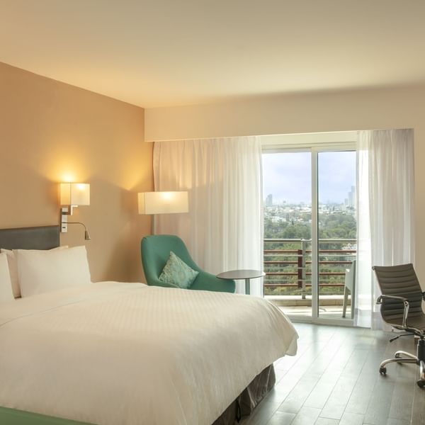 King bed in Deluxe Terrace Room with balcony at Fiesta Inn