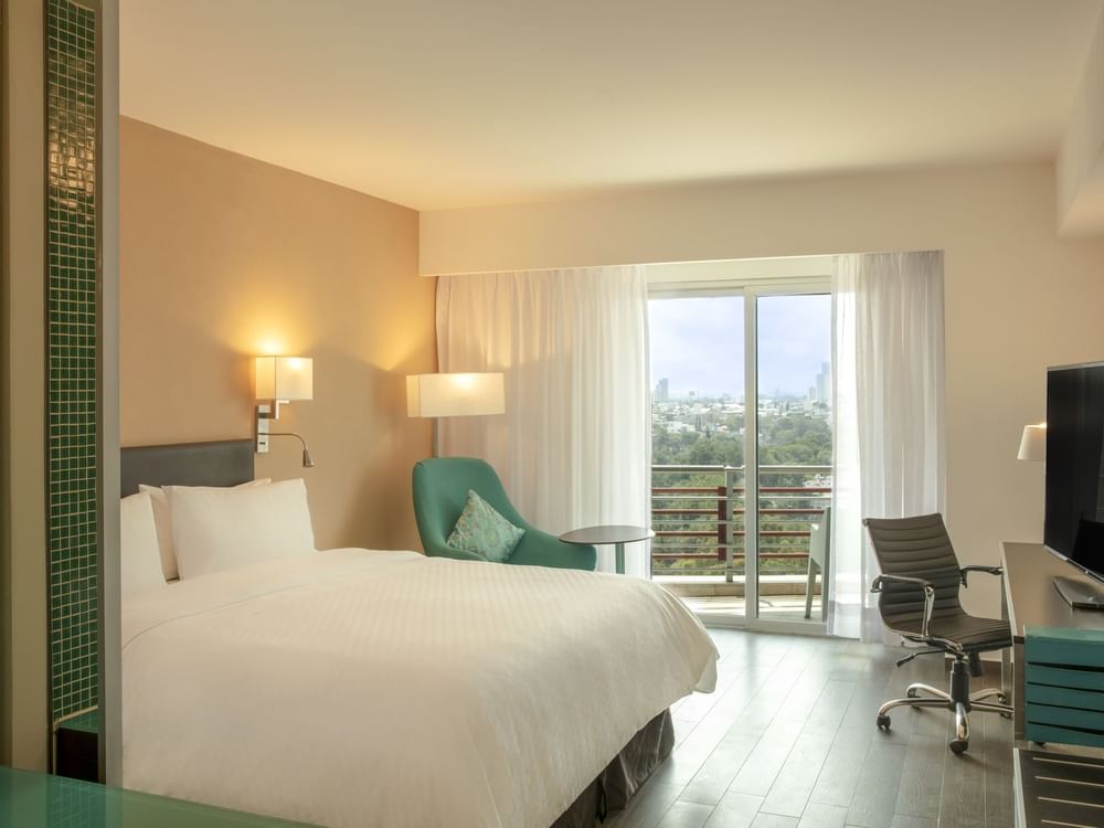 King bed in Deluxe Terrace Room with balcony at Fiesta Inn