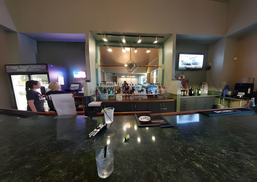 Dark green marble bar counter at Stagedoor Restaurant with liquor bottles and blue lighting at Branson Hillside Hotel