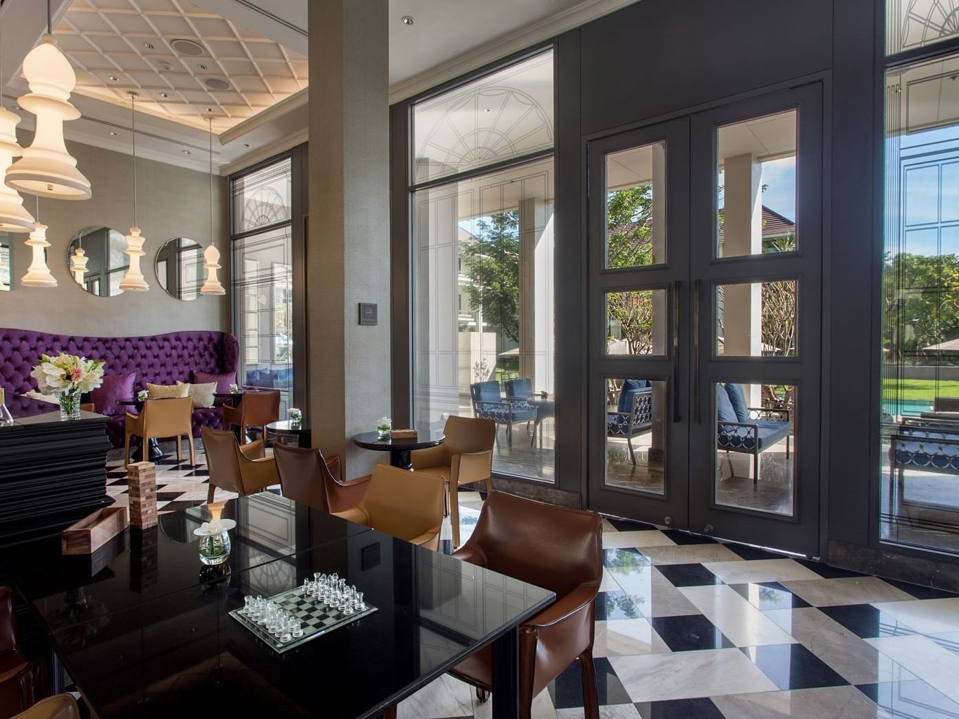 The Library interior with dining tables at U Hotels & Resorts