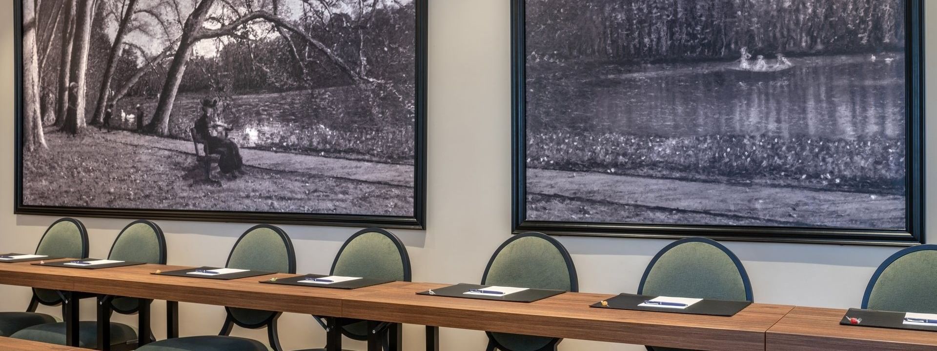 U-shaped table with cushioned chairs and black & white landscape art in Windsor meeting room at Warwick Reine Astrid - Lyon