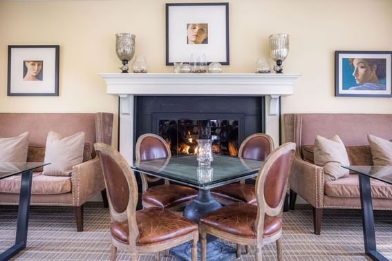 Meeting area with tables, chairs and a fireplace at the inn at Willow grove