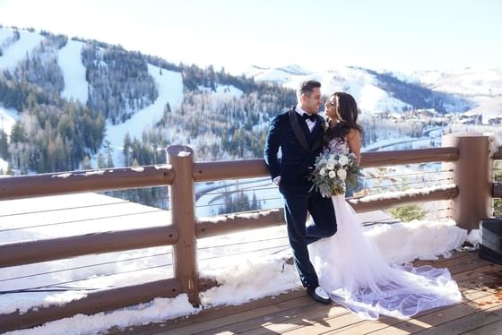 Wedded Couple posing outdoors in winter at Stein Eriksen Lodge