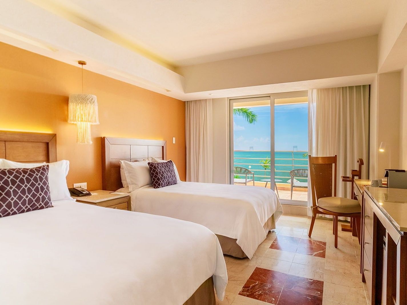 2 Double Camino Real Club featuring white linens, orange walls, and a sunny ocean balcony at Camino Real Veracruz