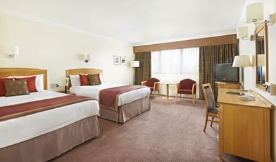 Standard Family Room with two large beds, two chairs and a TV at The Aberdeen Altens Hotel