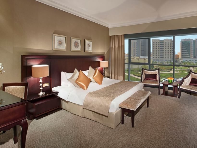 Luxury bed & city view in Premium Room at City Seasons Hotels
