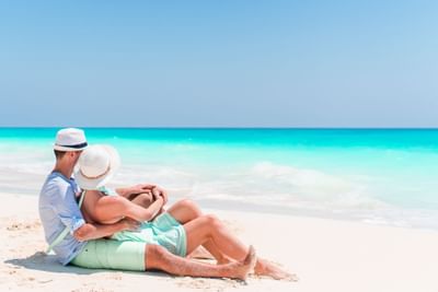 A couple relaxing on the beach near Southern Palms Beach Club