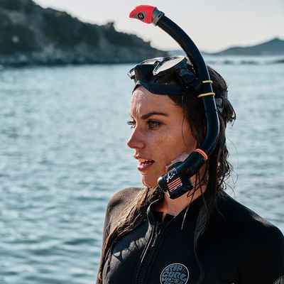 Female diver with snorkels in the sea near Falkensteiner Hotels