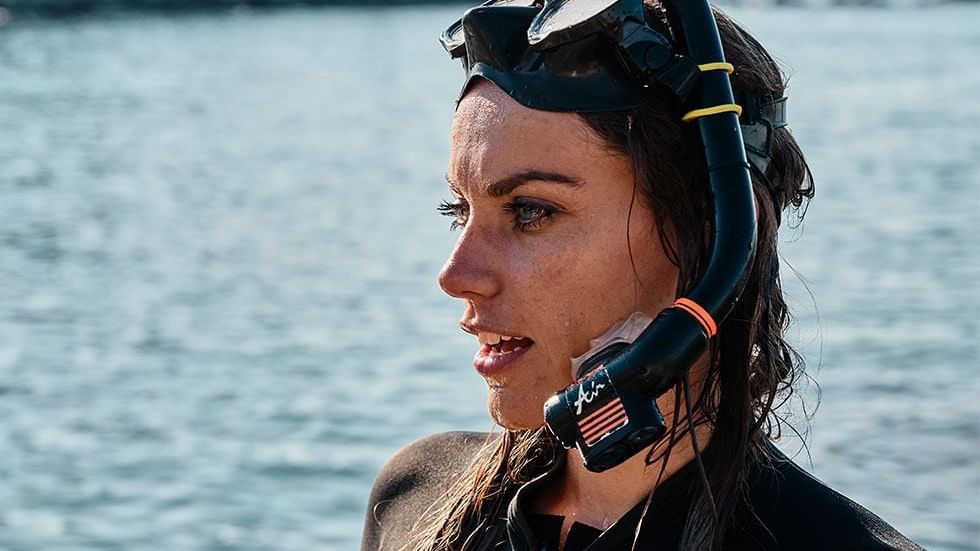 Female diver with snorkels in the sea near Falkensteiner Hotels