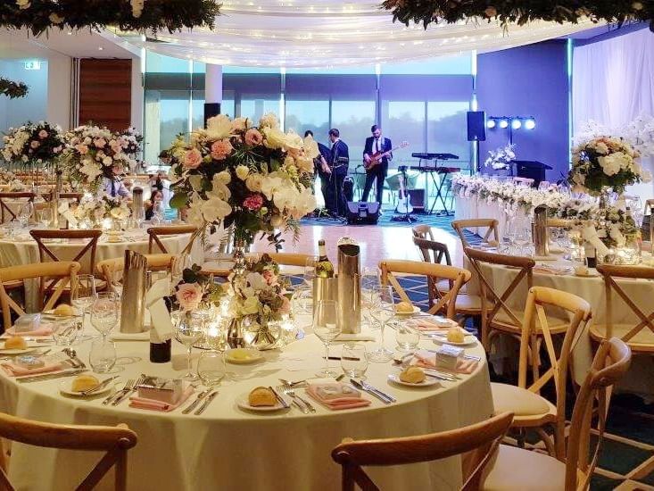 Attractive decorated table in wedding hall at Pullman Magenta Shores