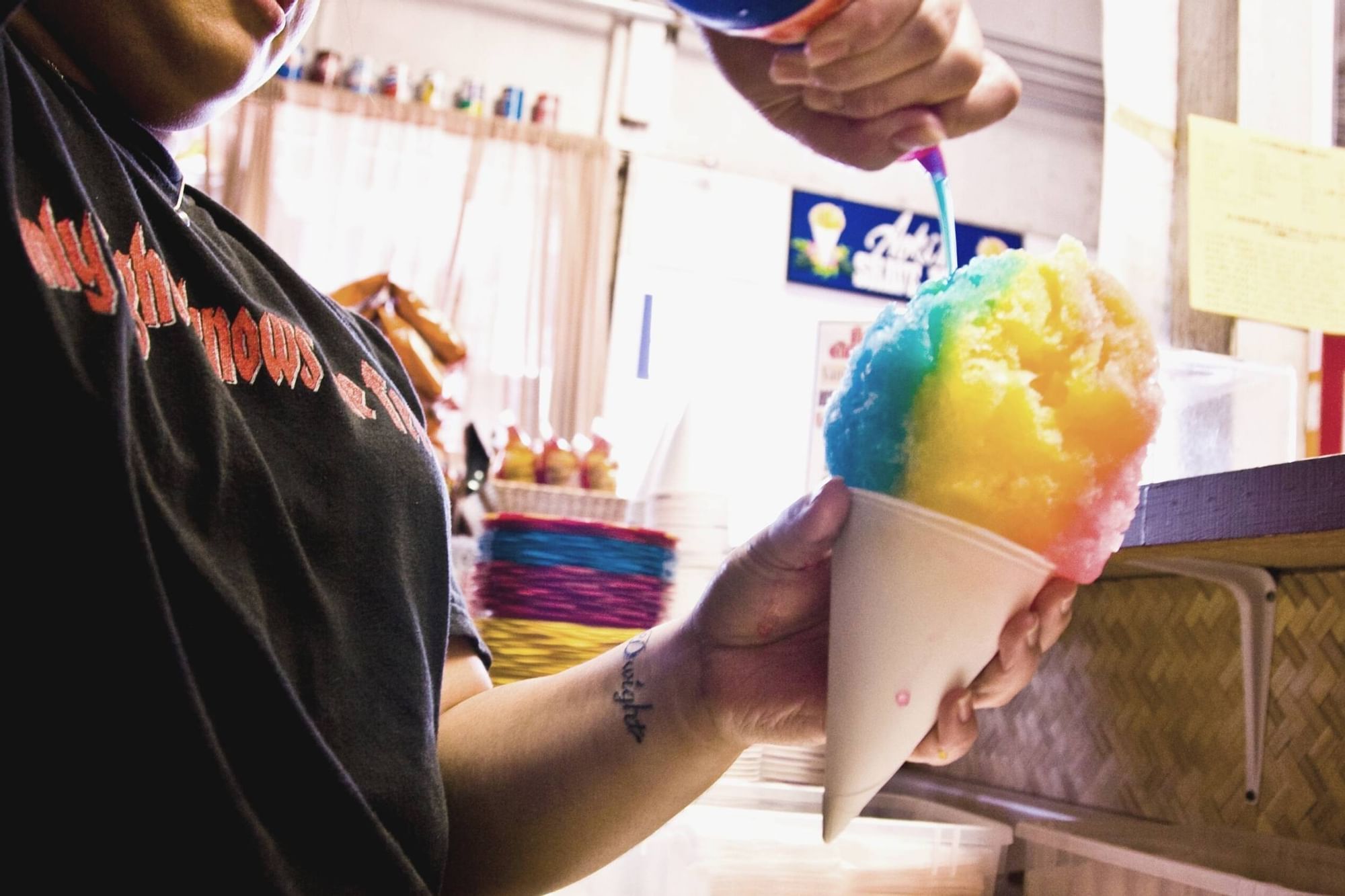 A lady preparing an Ice Cream at Aoki’s Shave Ice near Waikiki Resort Hotel