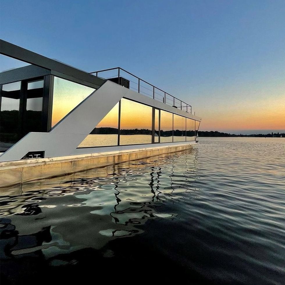 AQVA The Exclusive Water Loft reflecting the warm colors of the sunset sky near Falkensteiner Hotel & Spa Jesolo