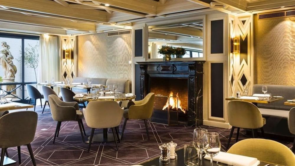 Restaurant & Bar area featuring a warm fireplace and seating at Hotel Barsey by Warwick