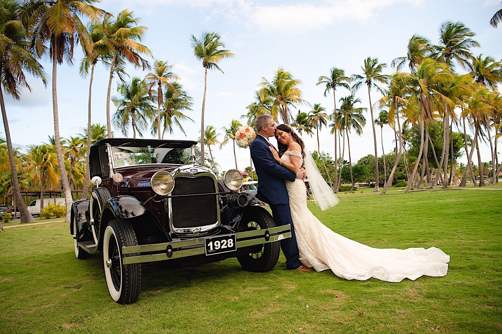 A couple standing near the car at Copamarina Weddings