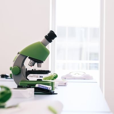 Close-up of a microscope on table at Falkensteiner Hotels