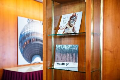 A glass showcase with photographs at Müggelseeperle Hotel