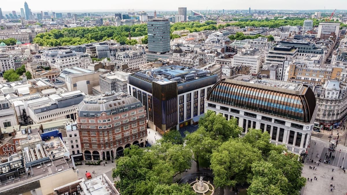 Stunning aerial view of London, showcasing the modern architecture of The Londoner Hotel amidst a bustling cityscape