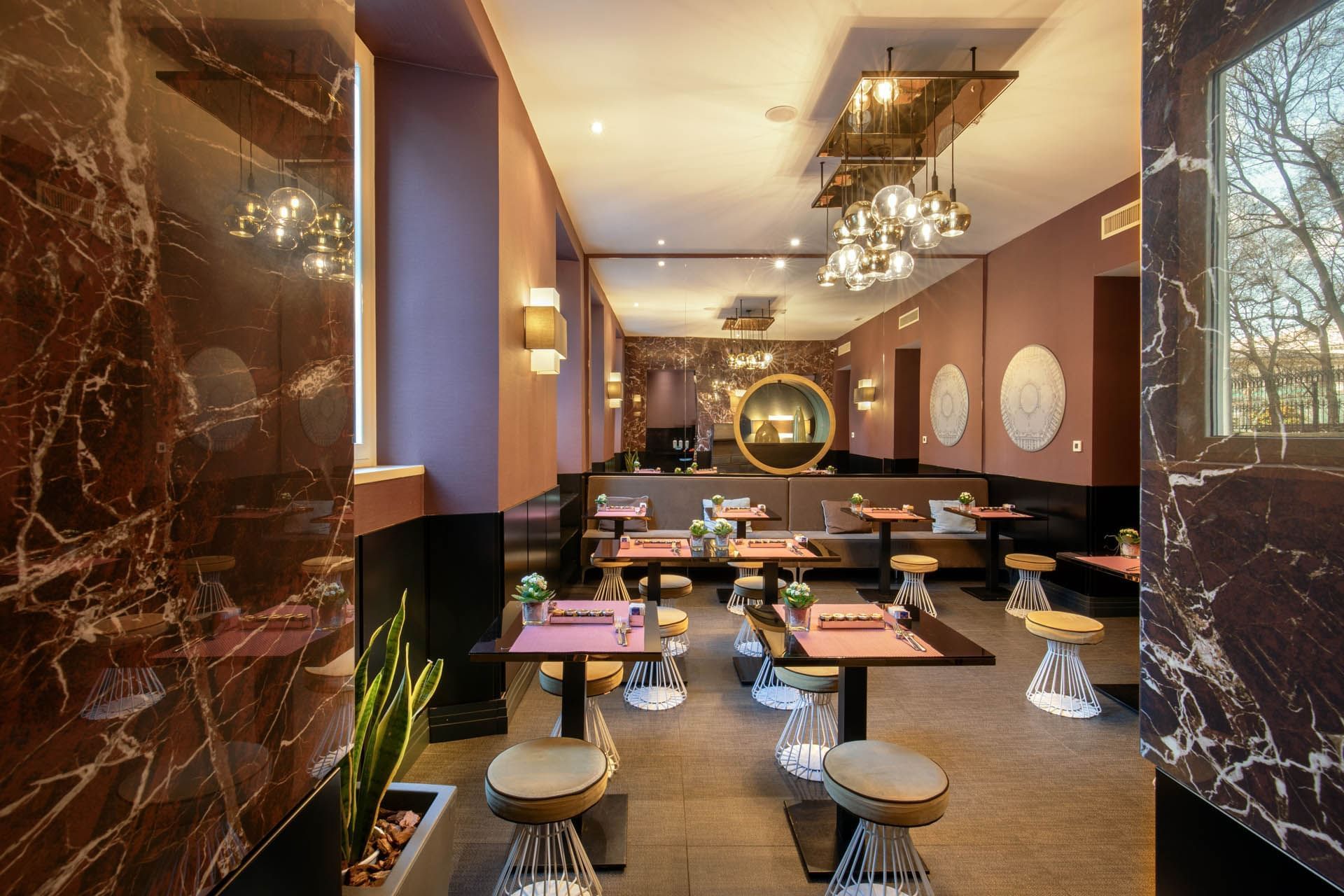 Chic breakfast restaurant with marble walls, modern lighting, stylish tables, and a warm color palette at The Guardian Hotel