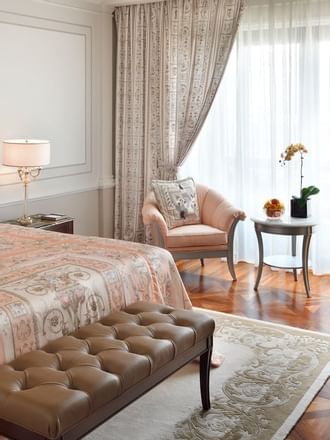 King bed, table lamp & chair in bedroom at Palazzo Versace