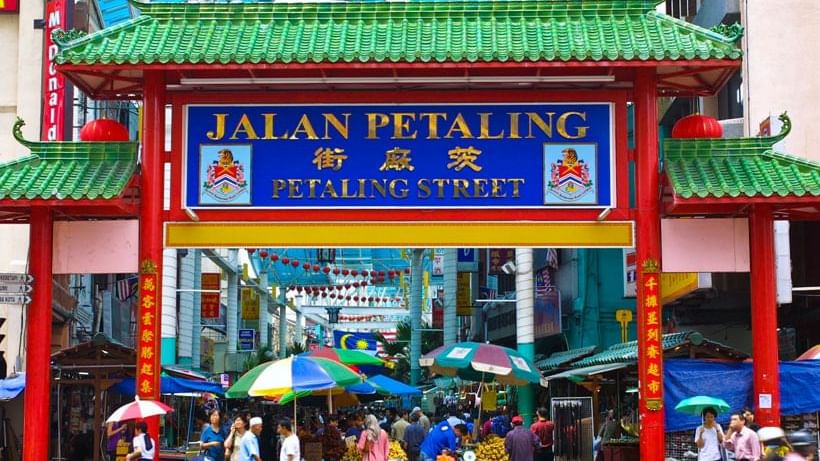 Iconic archway to Petaling Street Market with people and stalls near Sunway Velocity Hotel