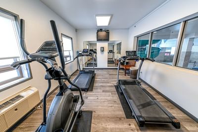 Fitness Centre with tread machines and wooden floors at Service Plus Inns & Suites