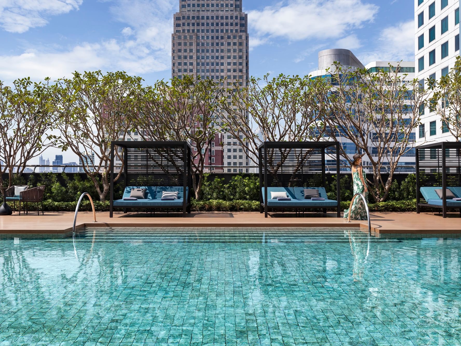 Outdoor pool with sun beds at Carlton Hotel Bangkok Sukhumvit