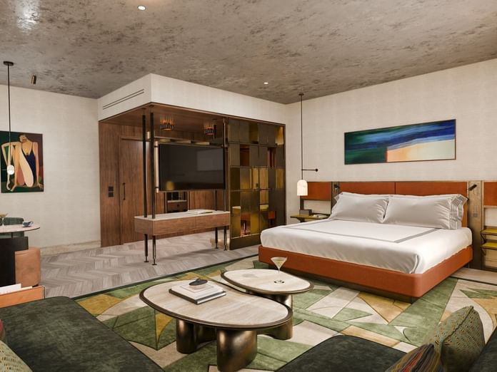 King bed facing a sofa & marble tables beside TV on wood stand in 1 King Bed Junior Suite with Terrace at Thompson Rome