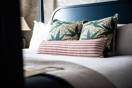 King bed with arranged pillows in a room at Richmond Hill Hotel