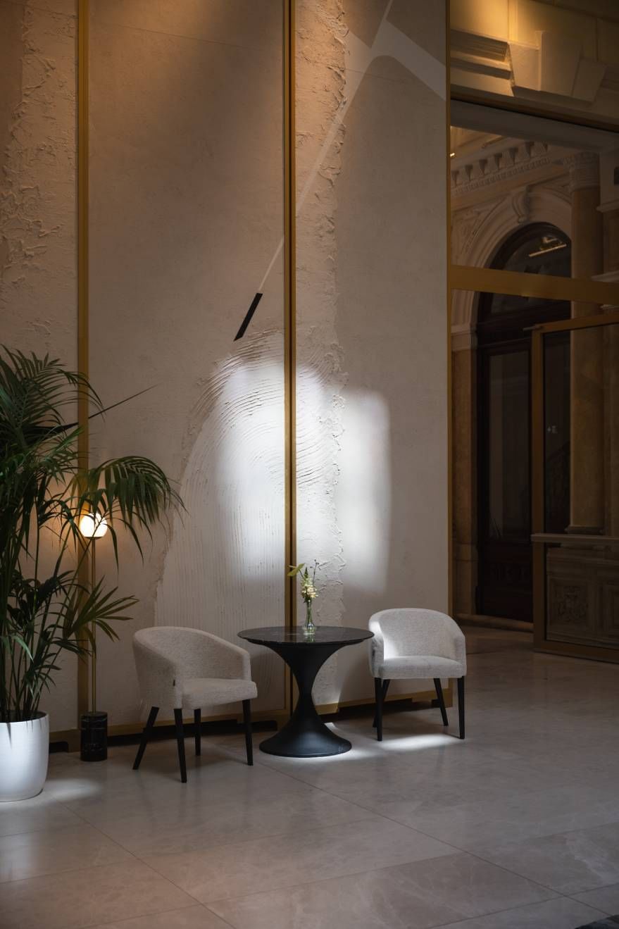 Lobby at Almanac Palais Vienna Austria hotel, featuring two chairs and a plant.