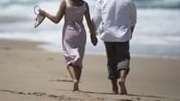 Couple walking in the beach at Pullman Magenta Shores