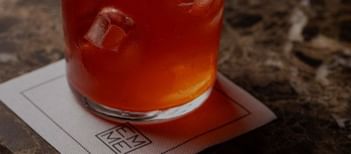 Rum and Aperol crush served on a table at EMME Restaurant