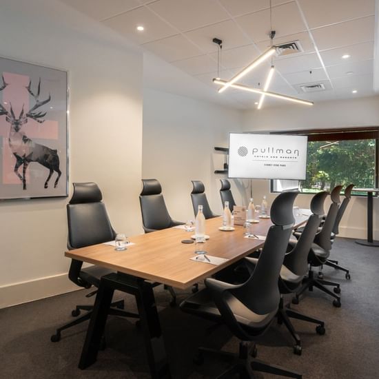 Boardroom set-up with TV in Frazer Room at Pullman Sydney Hyde Park