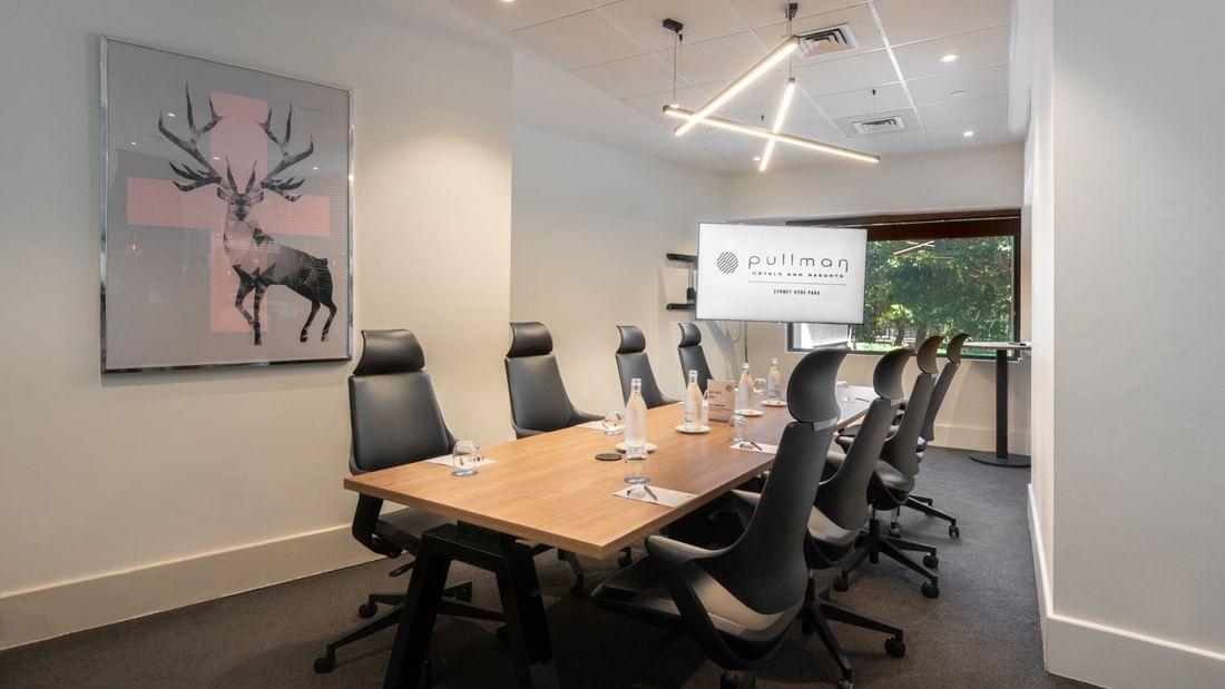 Boardroom set-up with TV in Frazer Room at Pullman Sydney Hyde Park
