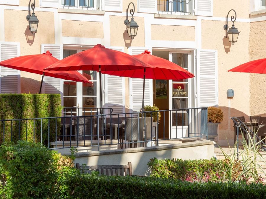 Outside restaurant at Hotel Saint Laurent with red umbrellas