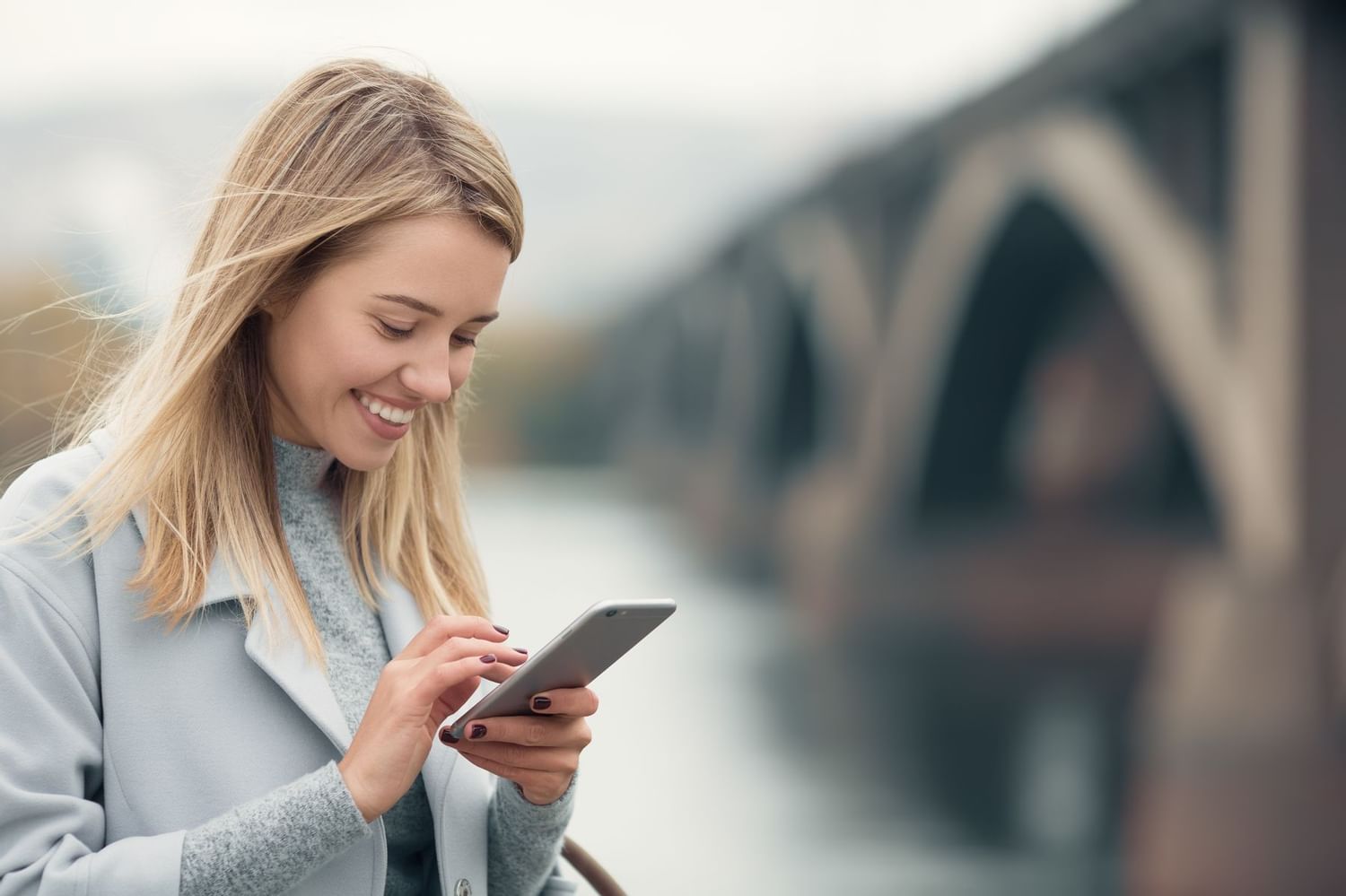 woman smiling at phone
