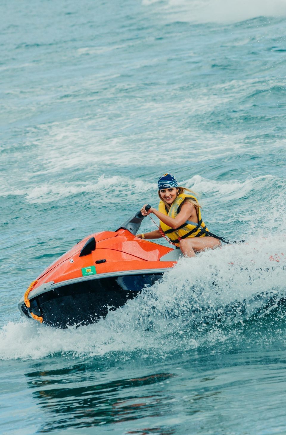 Lady riding a jet ski on the beach near Playa Blanca