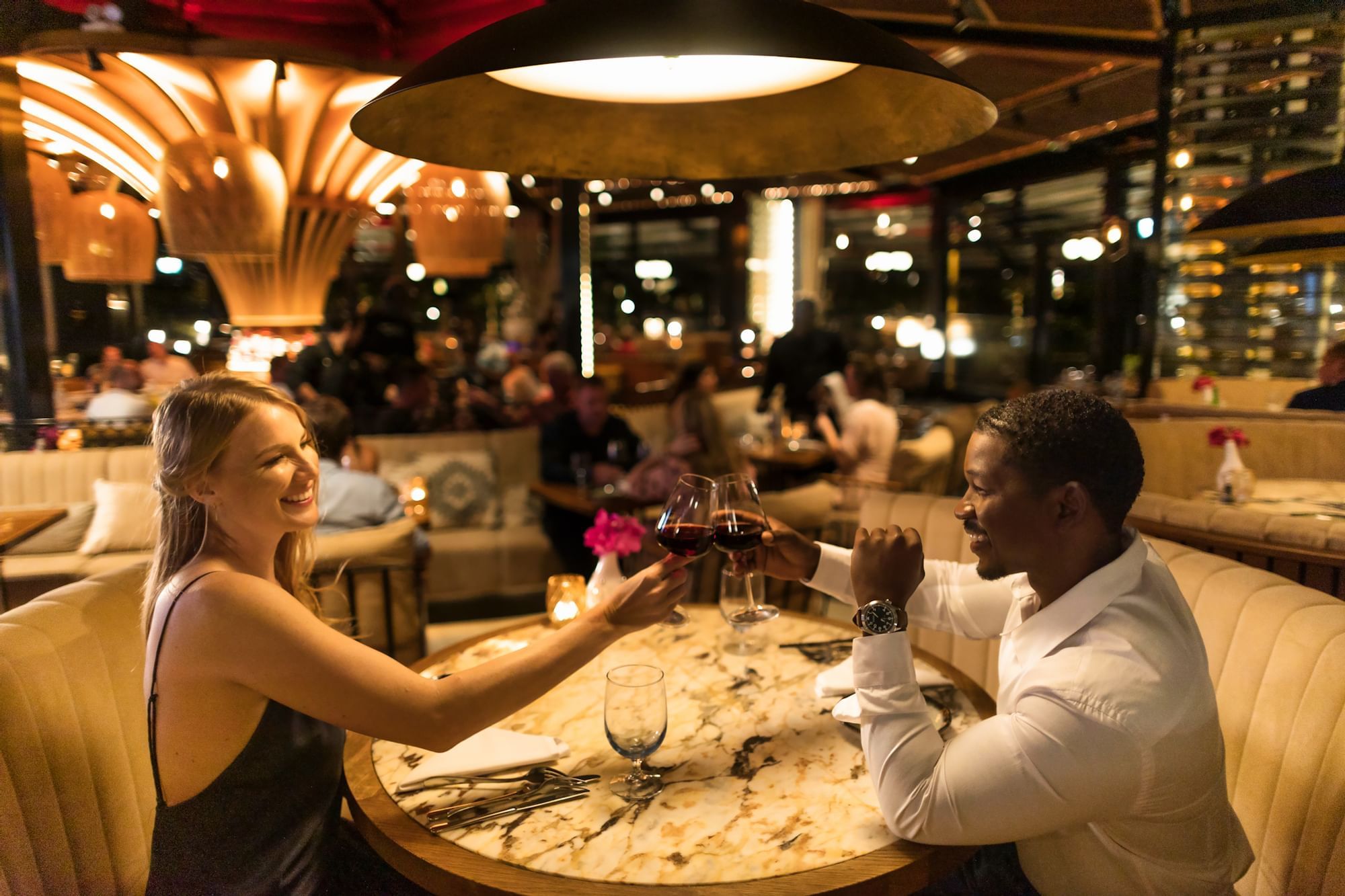 Couple toasting wine in the restaurant at Golden Rock Resort
