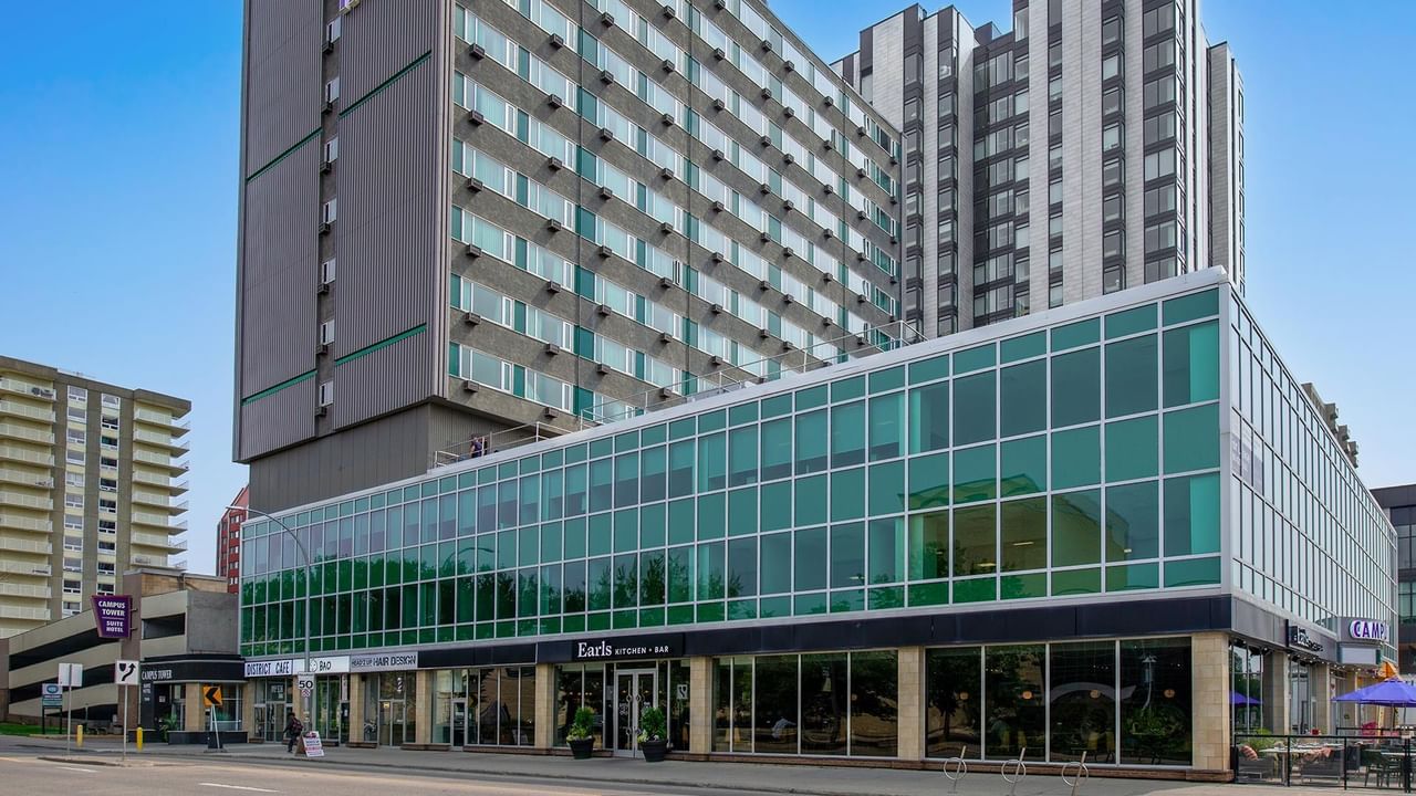 Exterior view of Campus Tower Suite Hotel building with a glass-fronted lower level.
