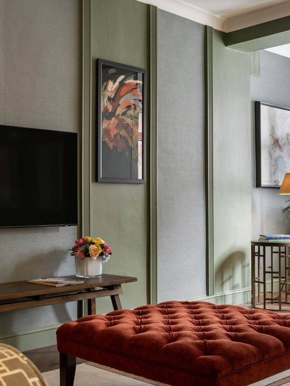 Living room with TV and furniture in a two-bedroom apartment at The Capital Hotel, Apartments & Townhouse