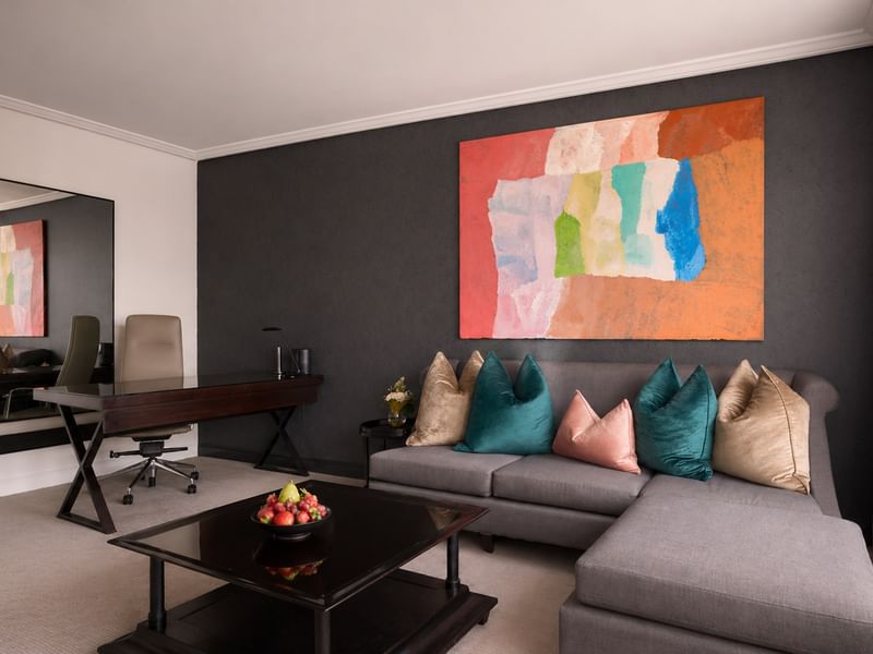Elegant living area with art, desk, and couch at Sofitel Brisbane Central in Brisbane City.