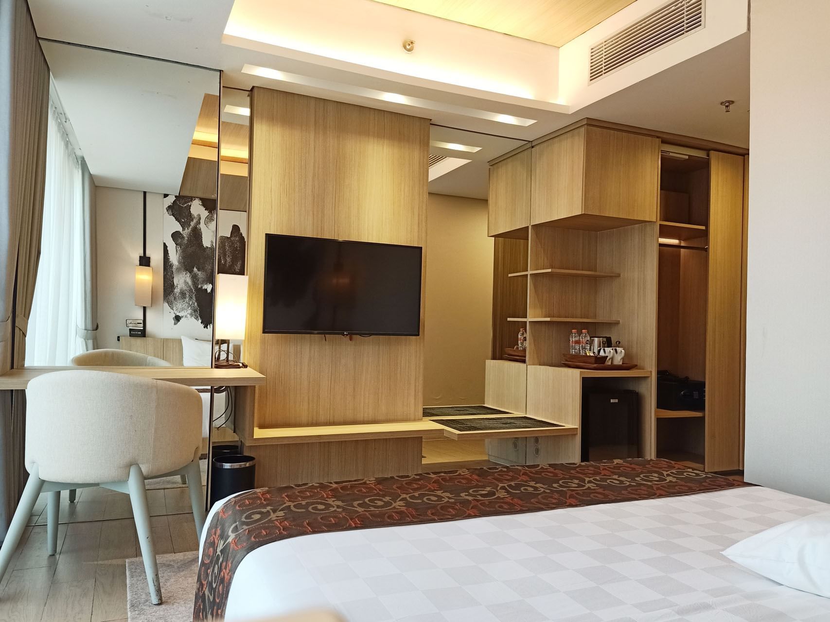 TV and furniture in King Bed Deluxe Room at LK Cikarang Hotel & Residences