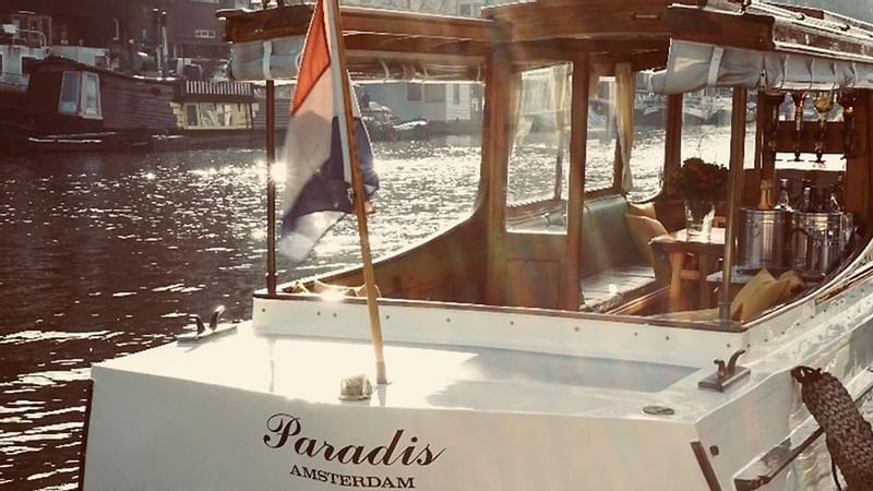 Paradis Amsterdam boat on water near Luxury Suites Amsterdam