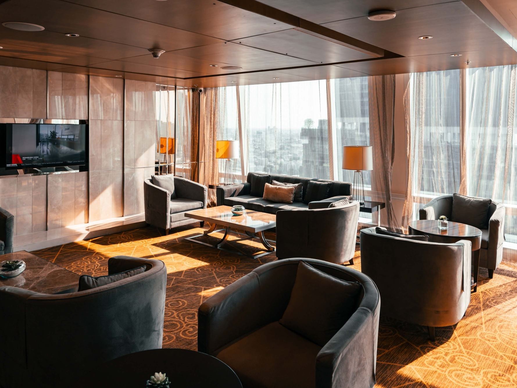 Executive Lounge with cozy chairs and TV at Eastin Hotels