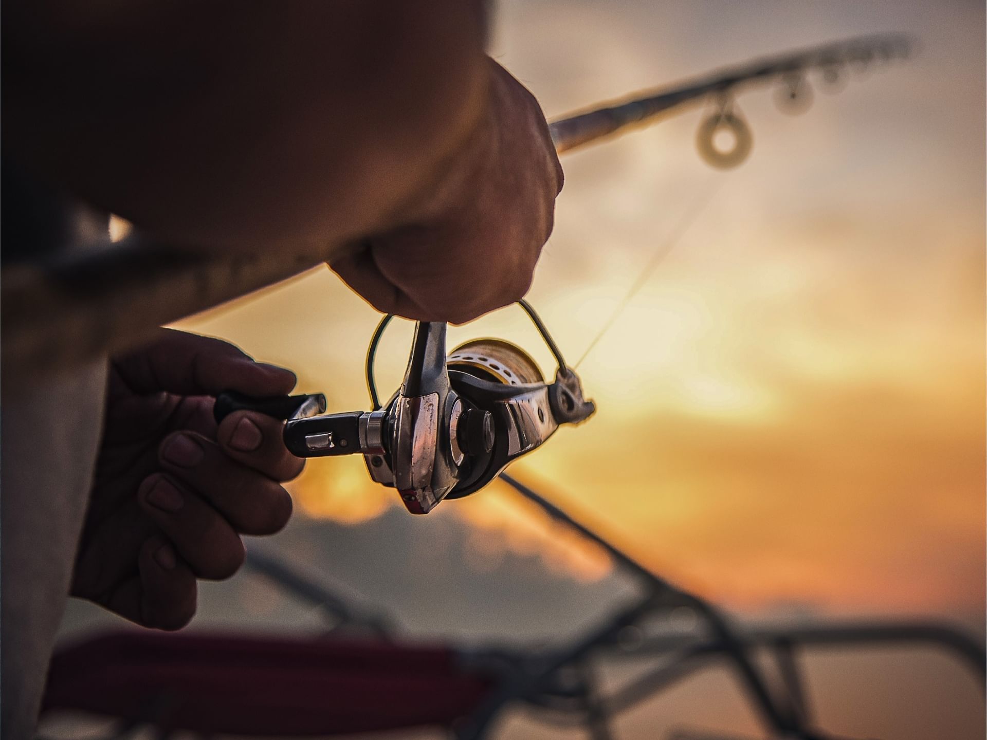 Close-up of man reeling in a fishing rod, Cala de Mar Resort