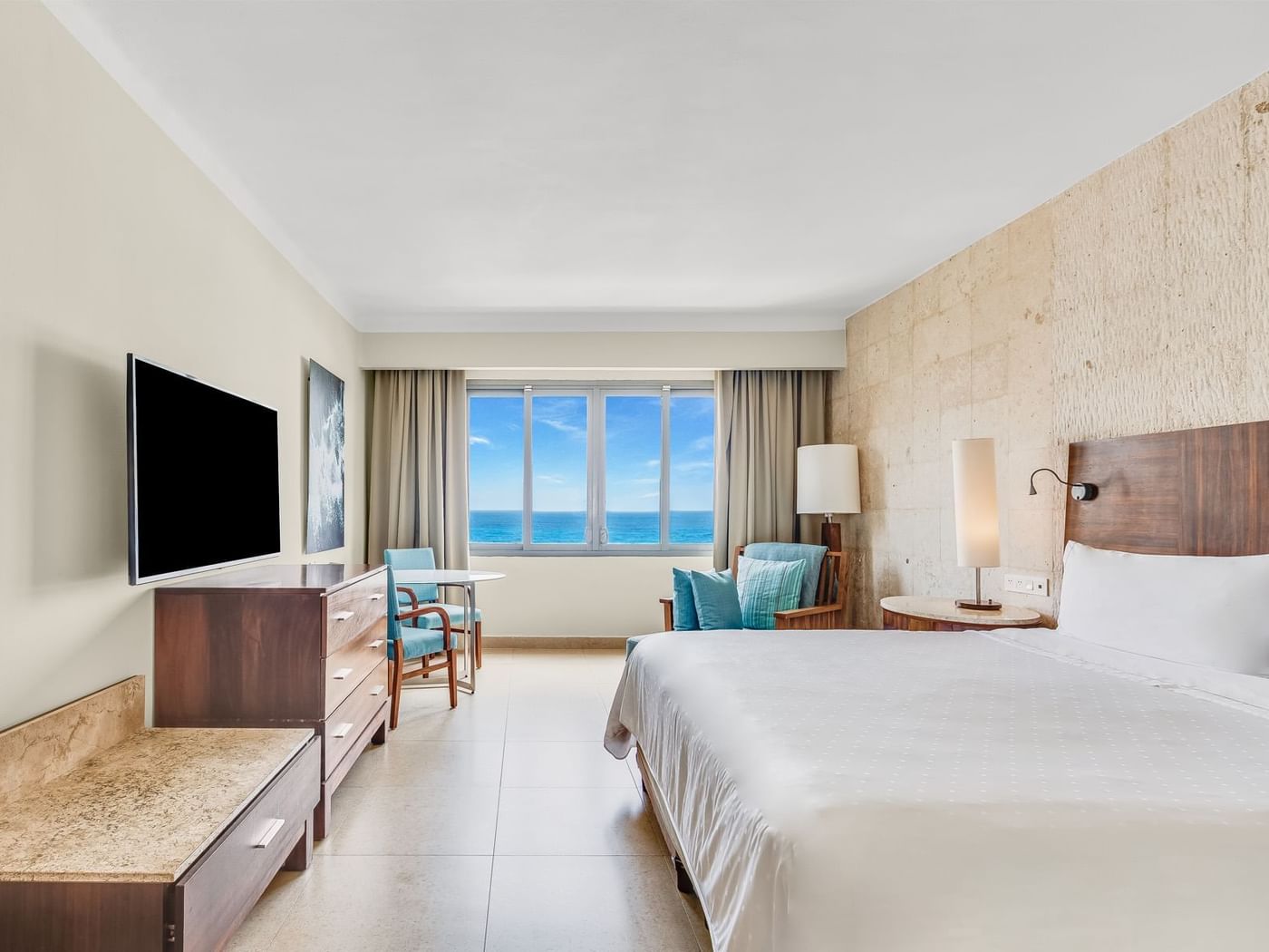 TV & sitting area facing the bed in Premium Ocean Front, 1 King at Fiesta Americana